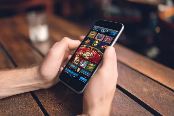 4777BET App — Fast, responsive, and optimized for all devices A cheerful woman in traditional clothing using her smartphone during a festive moment, showing how easily the 4777BET app fits into everyday life.